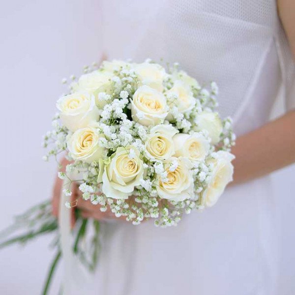 White roses and baby's breath wedding bouquet.
