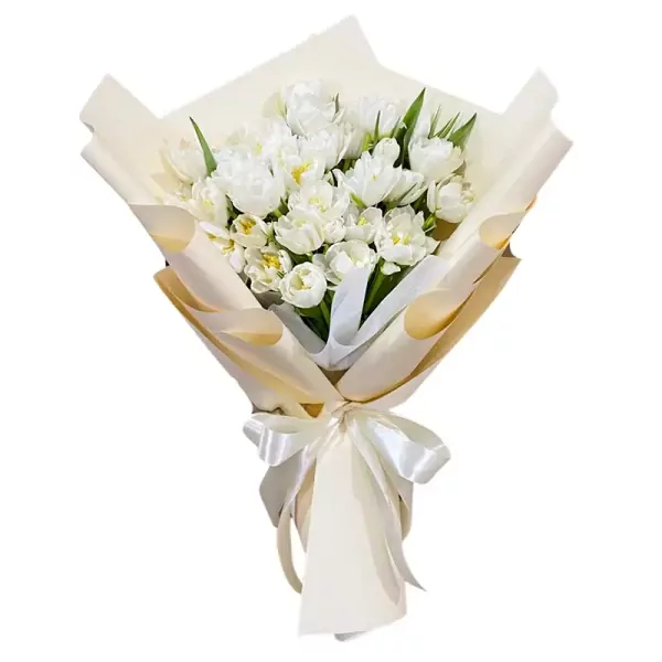 Bouquet of white tulips wrapped in cream and gold paper, tied with a white ribbon.