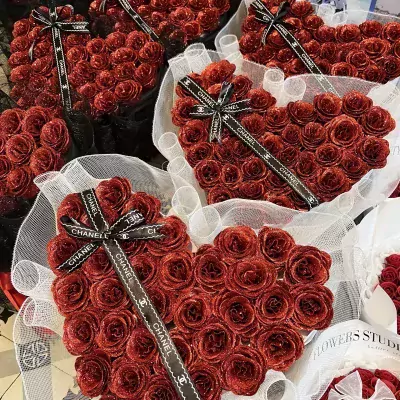 Heart-shaped bouquets of red glitter roses with Chanel ribbons.