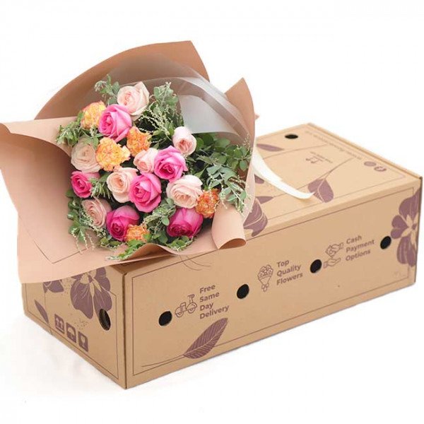Bouquet of pink and orange roses with a cardboard box.
