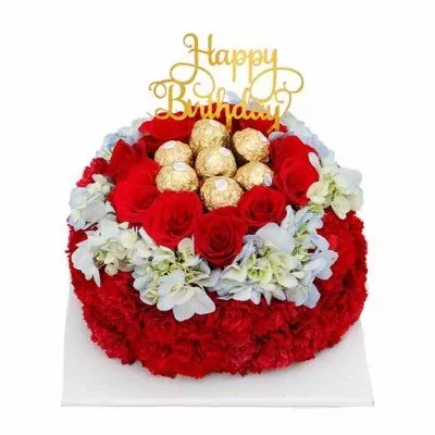 Round red flower cake topped with Ferrero Rocher chocolates and "Happy Birthday" topper.