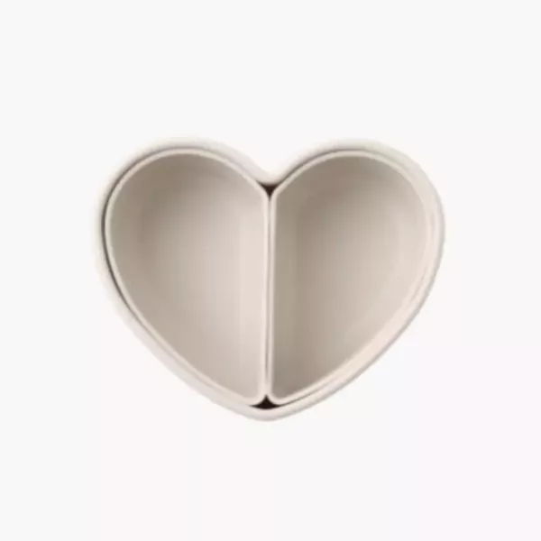 A heart-shaped lunchbox with two compartments, in a light beige color.