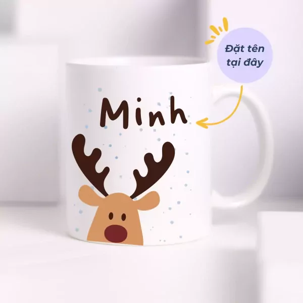 Ceramic mug with a reindeer design and the name "Minh" printed on it.