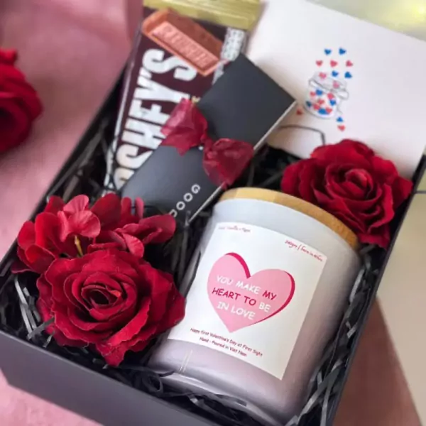Valentine's gift box with Hershey's bar, candle, red roses, and card.
