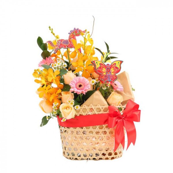 Basket of yellow orchids, peach roses, pink gerberas, and decorative dragon and butterfly.