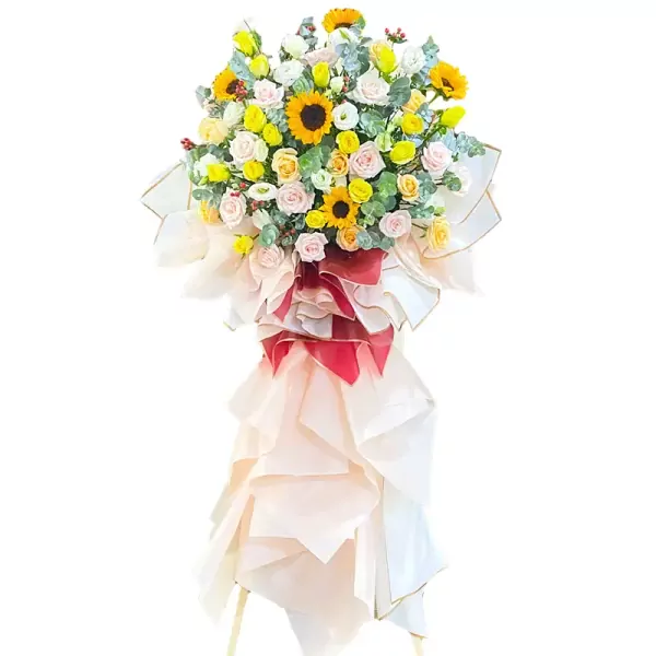 Grand opening flower stand with sunflowers, roses, and other flowers.