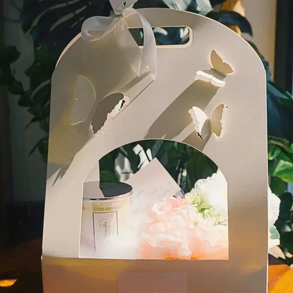 Fairytale Scented Candle Gift Basket with delicate butterflies, featuring a candle, flowers, and a card.
