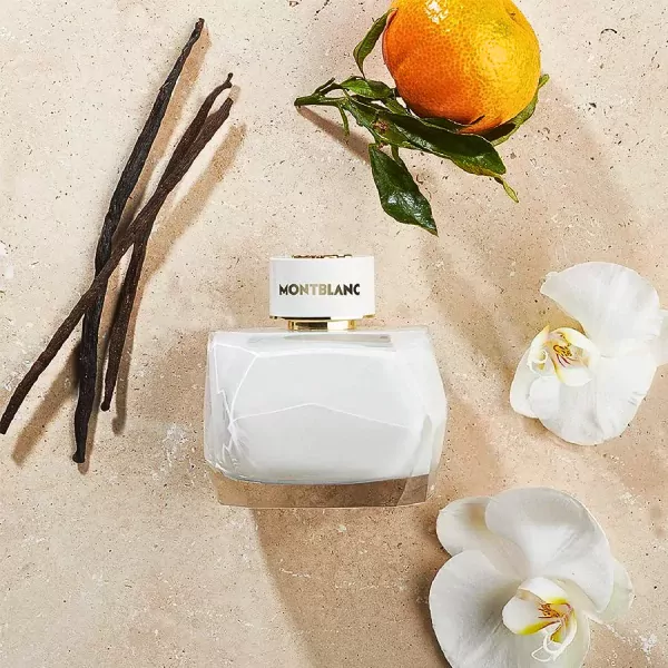 Montblanc Signature Eau de Parfum bottle with vanilla, orange, and orchid on a textured background.