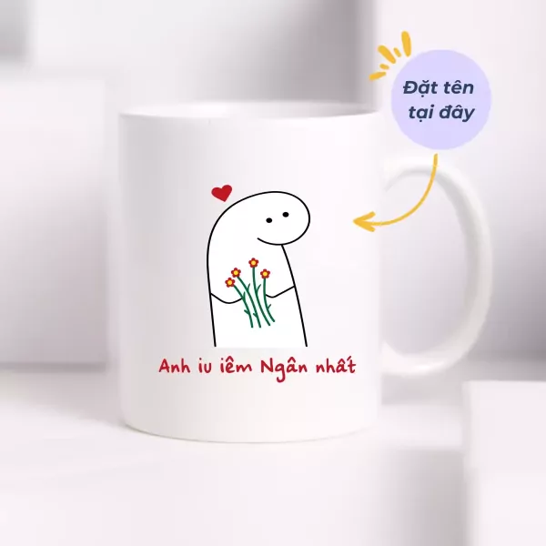 White ceramic mug with a cartoon character holding flowers and Vietnamese text saying "I love you the most."