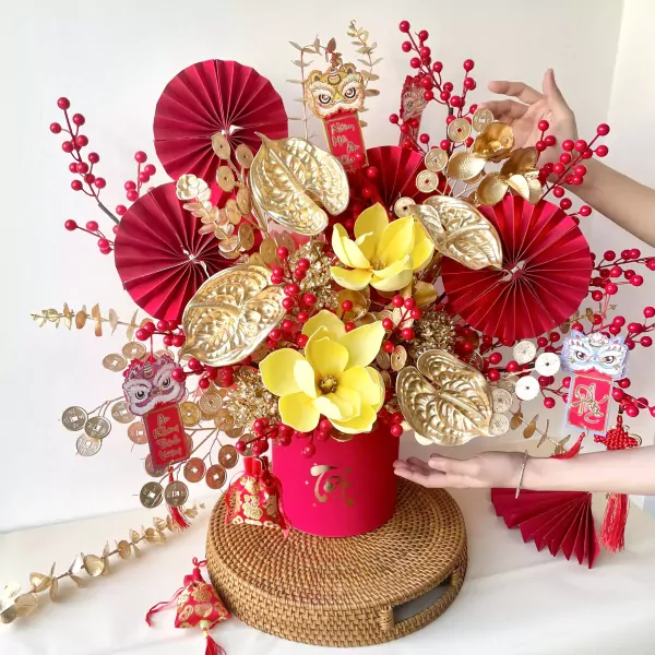 Red and gold flower box with traditional decorations for Lunar New Year celebration.