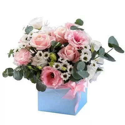 Bouquet of pink roses, lisianthus, and daisies in a light blue box with a pink ribbon.
