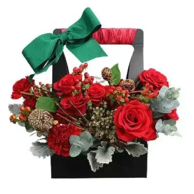 Red roses, carnations, berries, pinecones in a black gift basket with green ribbon.