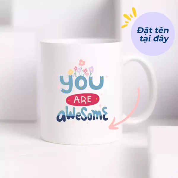 White ceramic mug with "you ARE awesome" text and small flowers design.