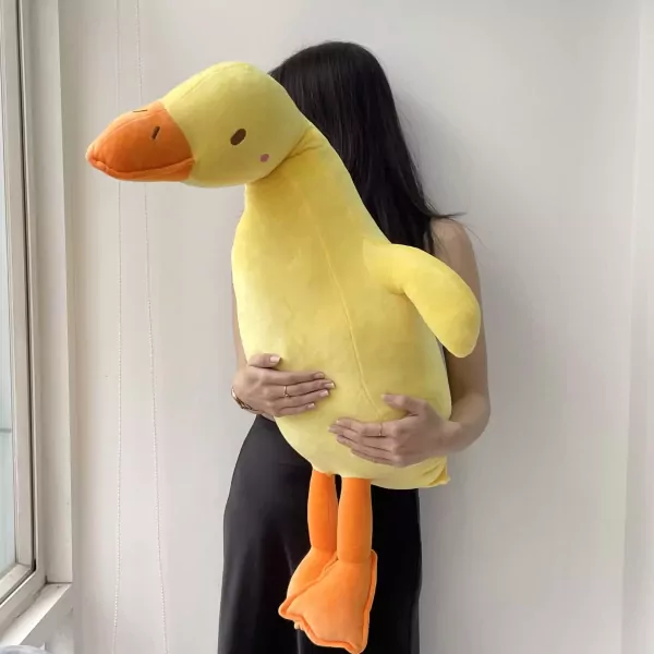 Giant yellow duck plushie held by a person.