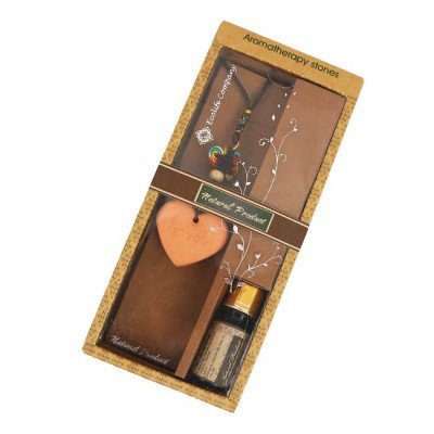 Aromatherapy gift set with heart-shaped scented stone, essential oil, and dried flowers.
