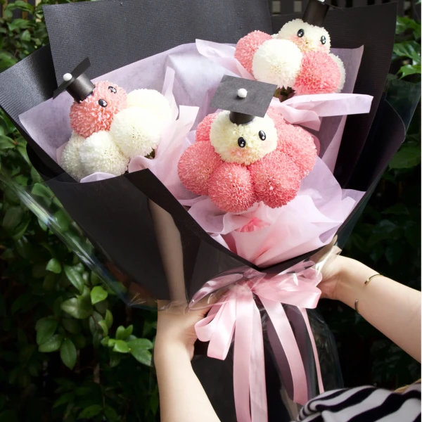 Pink and white ping pong chrysanthemum graduation bouquet.