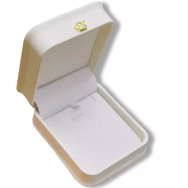 Open white and gold jewelry box with a tiny crown charm.