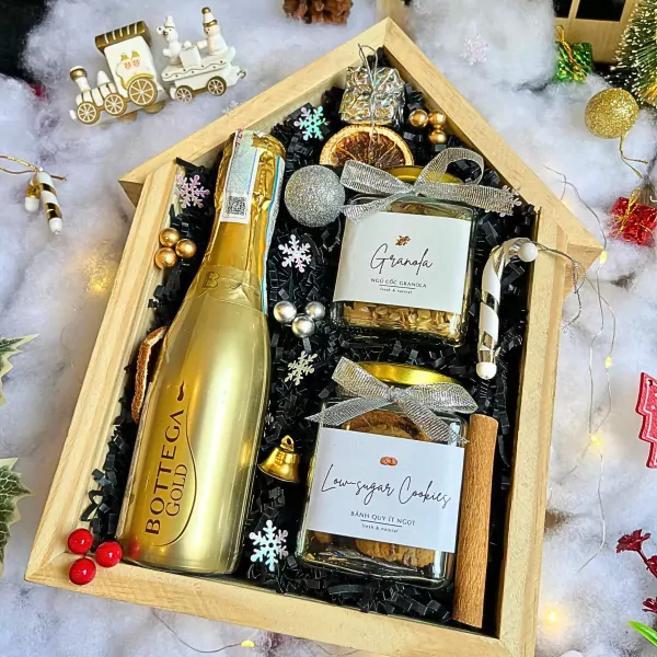 Christmas gift box with Bottega Gold wine, granola, cookies, and festive decorations.