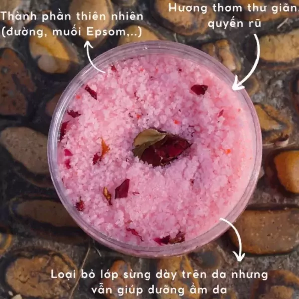 Pink rose-infused bath salts in a clear jar with text highlighting natural ingredients and benefits.