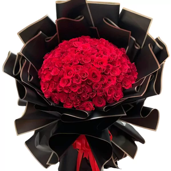 Bouquet of 99 vibrant red roses wrapped in black and gold paper.