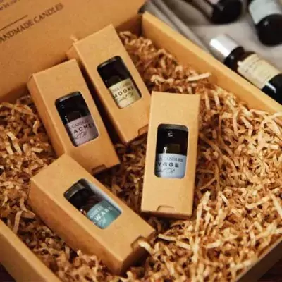 Gift box with four small essential oil bottles, "HYGGE", "MOONIE", "PEACHES", and "WARM" labeled.