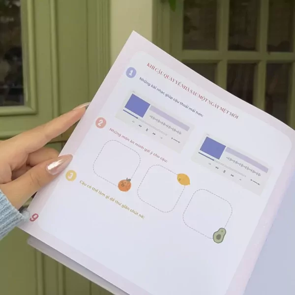 Hand pointing to notebook with prompts about music and snacks.