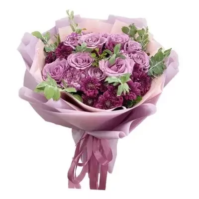 Bouquet of purple roses and carnations with pastel pink and lavender wrapping.