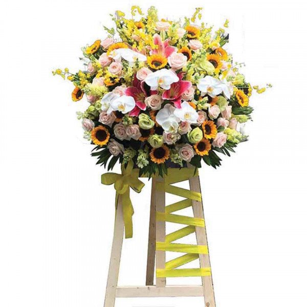 Large flower stand with sunflowers, roses, orchids, and lilies.