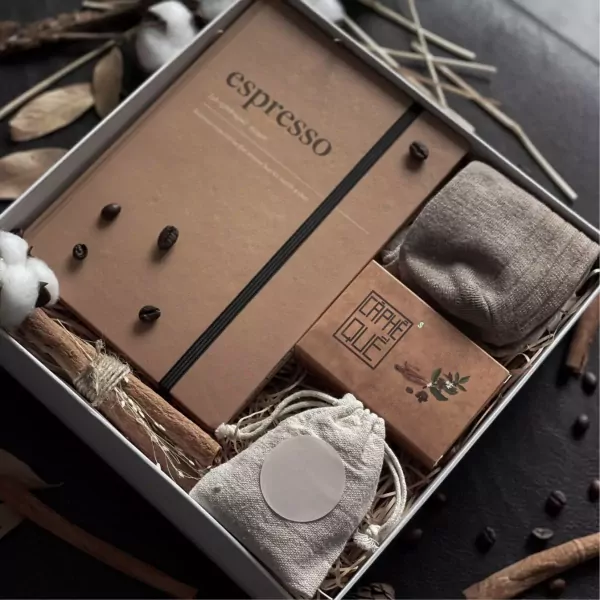 Espressiano gift set with notebook, socks, small bag, and coffee beans in a box.