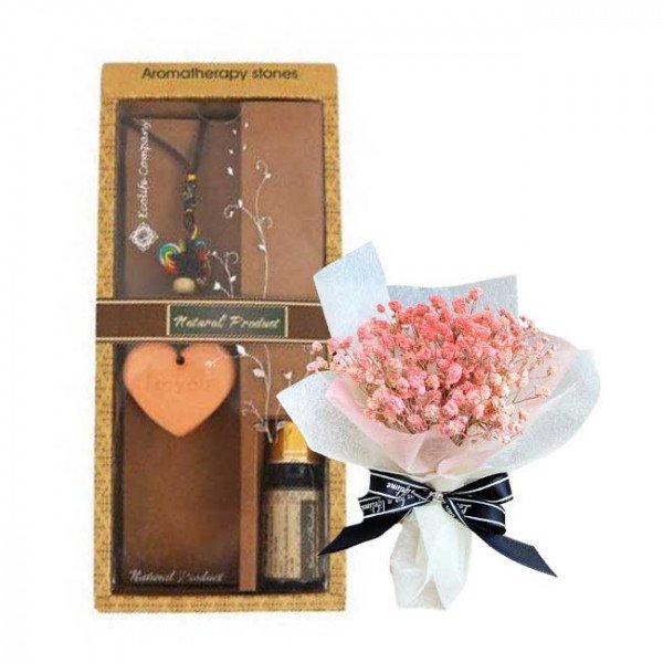 Aromatherapy gift set with heart-shaped scented stone, essential oil, and dried flowers.