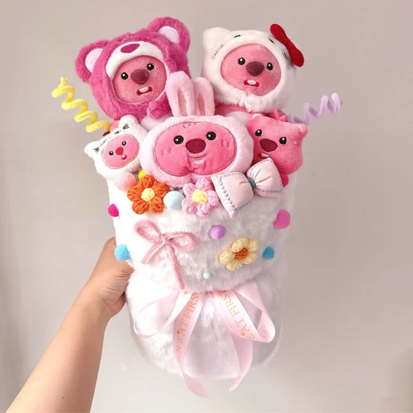 Pink Loopy plush toys bouquet with flowers and ribbons, held by a hand.