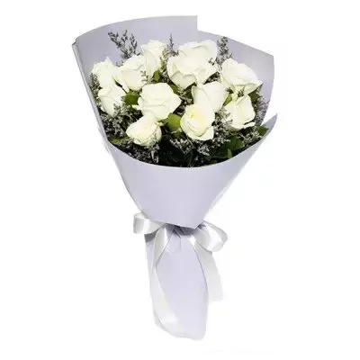 A bouquet of white roses with delicate greenery, wrapped in light purple paper and tied with a white ribbon.
