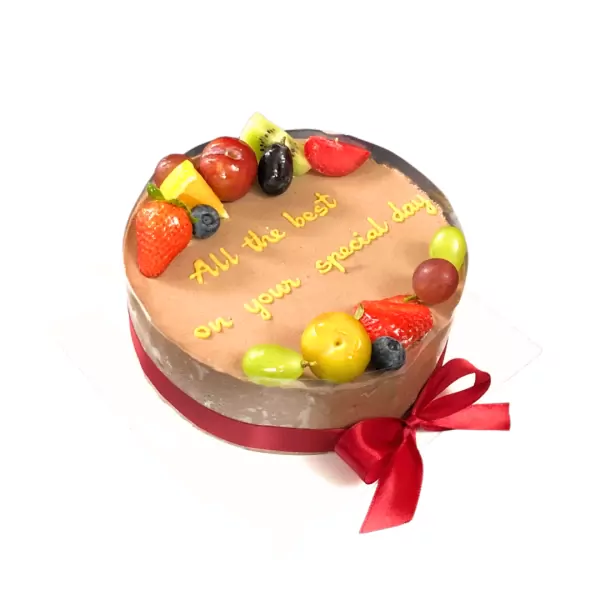Chocolate mousse cake with fresh fruit and a red ribbon, decorated with "All the best on your special day."