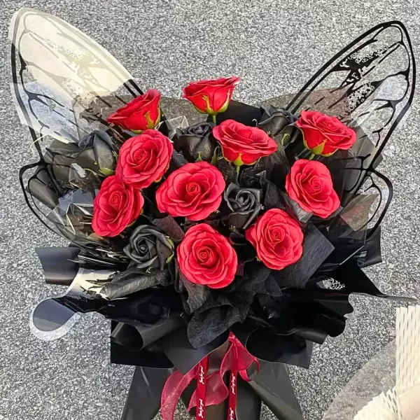Bouquet of red and black roses with decorative butterfly wings.