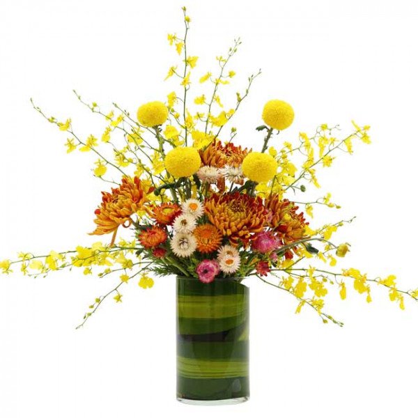 Golden Aurora floral arrangement with yellow orchids, orange and yellow chrysanthemums in a green striped vase.