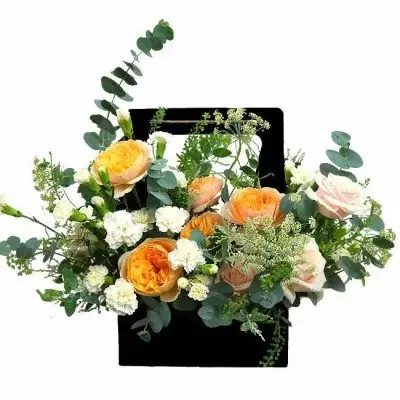 Black basket with orange and pink roses, white carnations, and eucalyptus.
