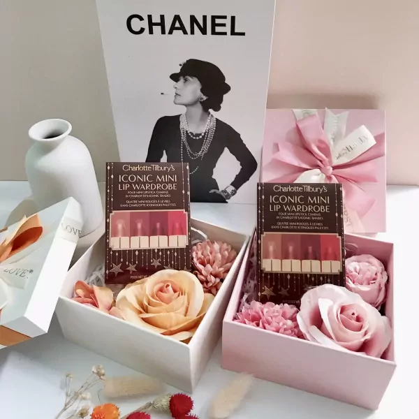 Charlotte Tilbury Iconic Mini Lip Wardrobe lipstick set in gift boxes with flowers.