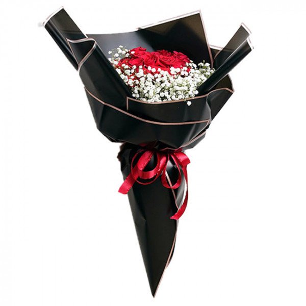 Bouquet of red roses and baby's breath wrapped in black paper, tied with a red ribbon.