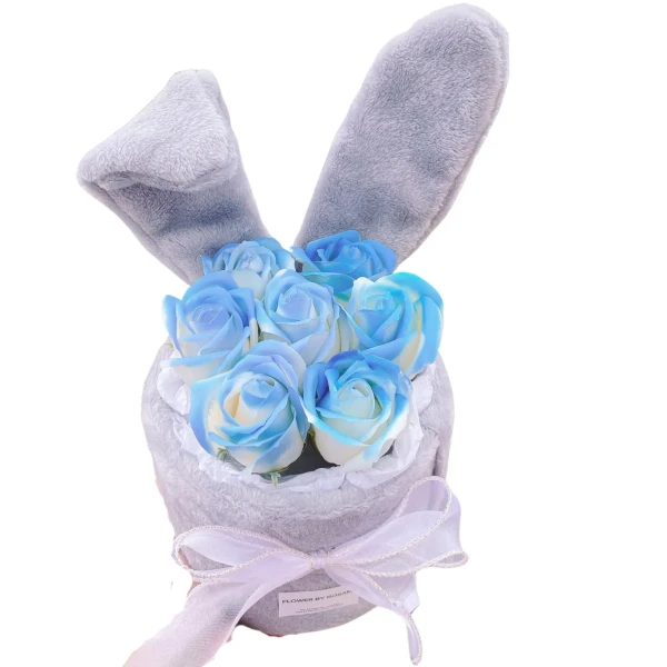 Woman holding pink gift bags with floral bouquets inside, one bag is transparent with a bow.