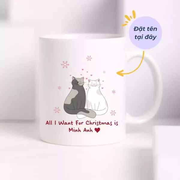 White mug with two cats, snowflakes, and "All I Want For Christmas is Minh Anh" text.