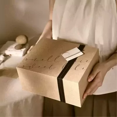 Kraft paper gift box with "sweet bee" calligraphy, tied with black ribbon.