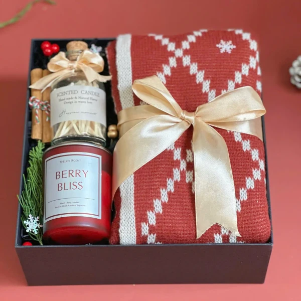 Christmas gift box with red knit scarf, Berry Bliss candle, and scented matches.