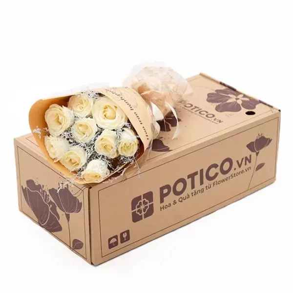 White roses in a bouquet on a brown box with a logo.