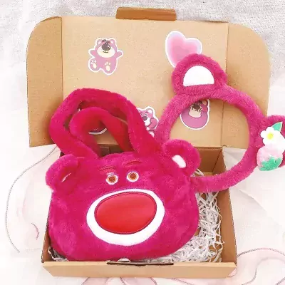 Pink Lotso Bear plush handbag with matching headband in a gift box.