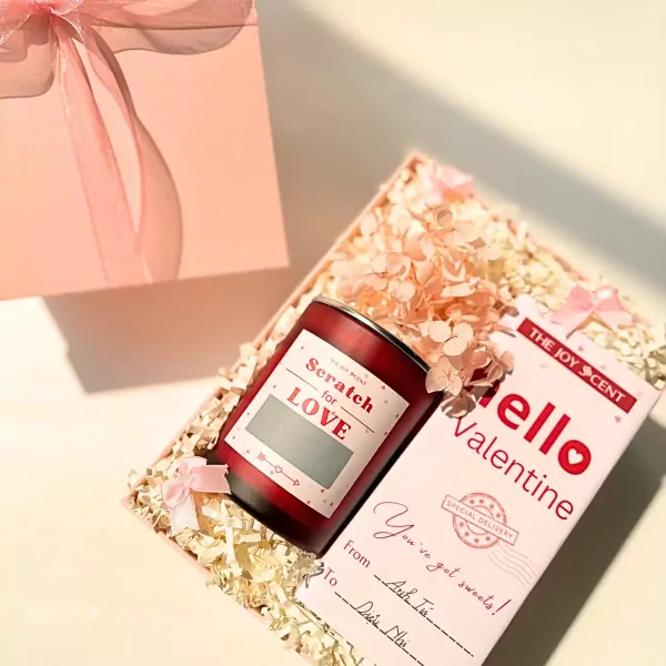 Valentine's gift box with candle, card, and dried flowers.