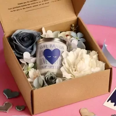 Love Spell Scented Candle gift set with flowers and hearts in a brown box.