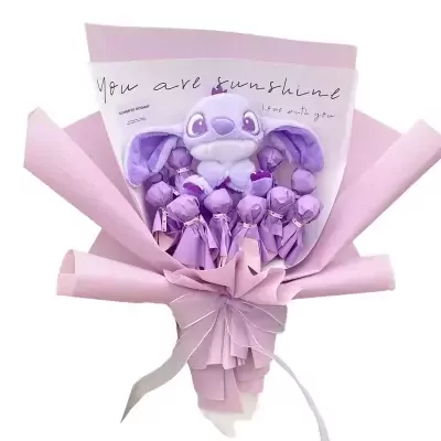 Purple Stitch candy bouquet with wrapped candies and a pink bow.