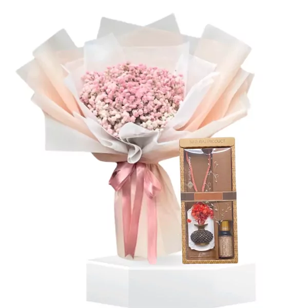 Pink baby's breath bouquet with a gift box containing a necklace, stone diffuser, and essential oil.