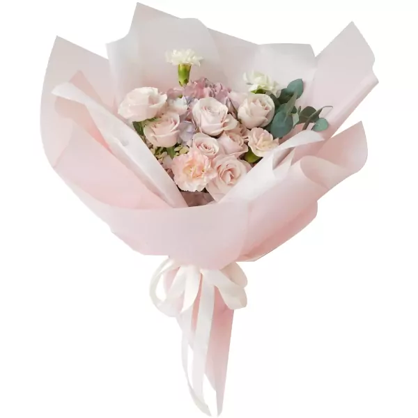 Pastel bouquet of roses, hydrangeas, and carnations with pink paper and ribbon.