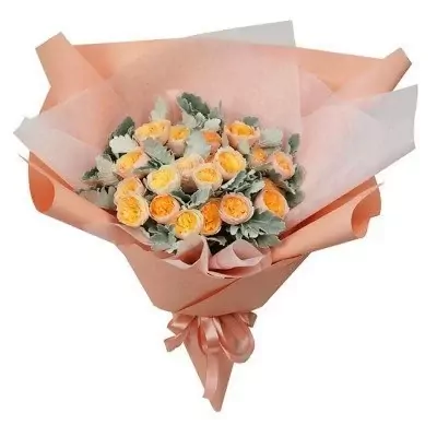Bouquet of yellow and orange roses with grey-green foliage, wrapped in peach paper and tied with a peach ribbon.